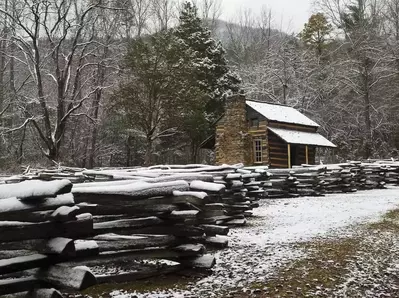 john oliver cabin with snow